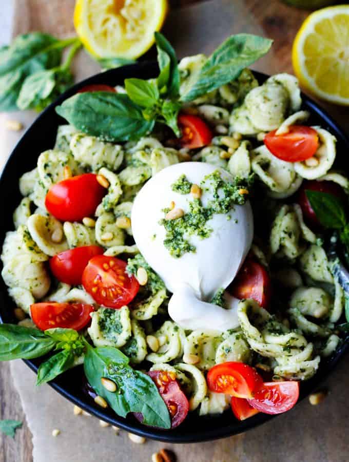 Burrata Pasta with Lemon Basil Pesto Sauce, Cherry Tomatoes and Pine Nuts on a plate.