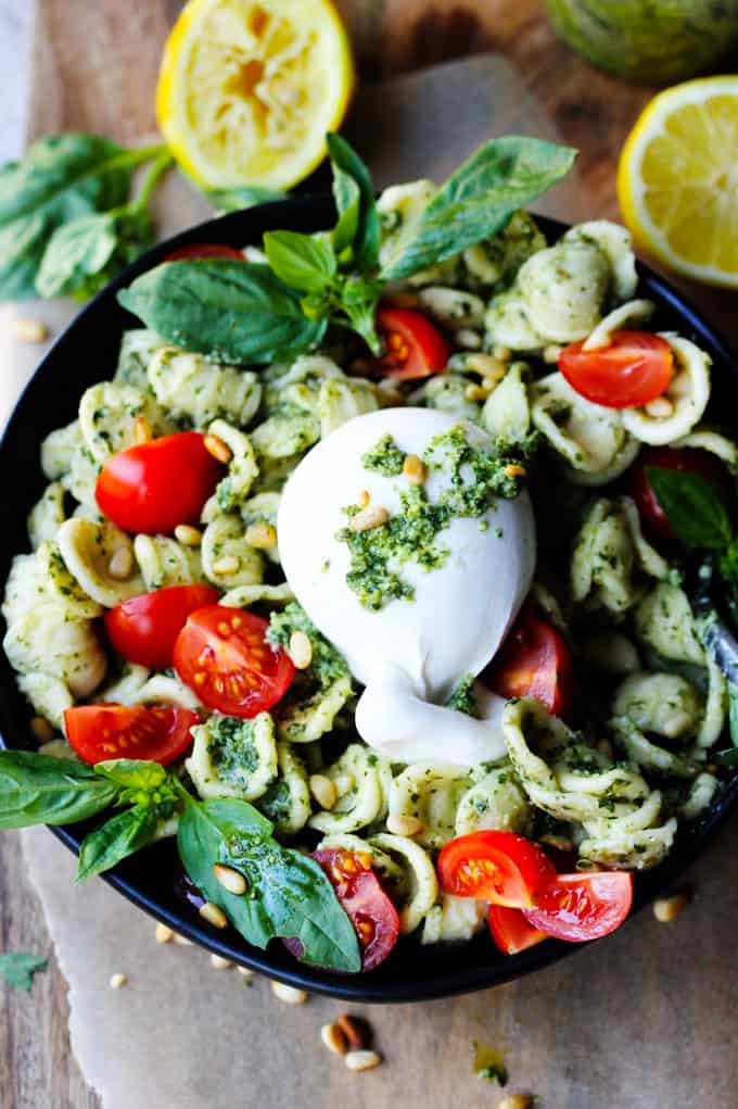 Burrata Pasta with Lemon Basil Pesto Sauce, Cherry Tomatoes and Pine Nuts on a plate.