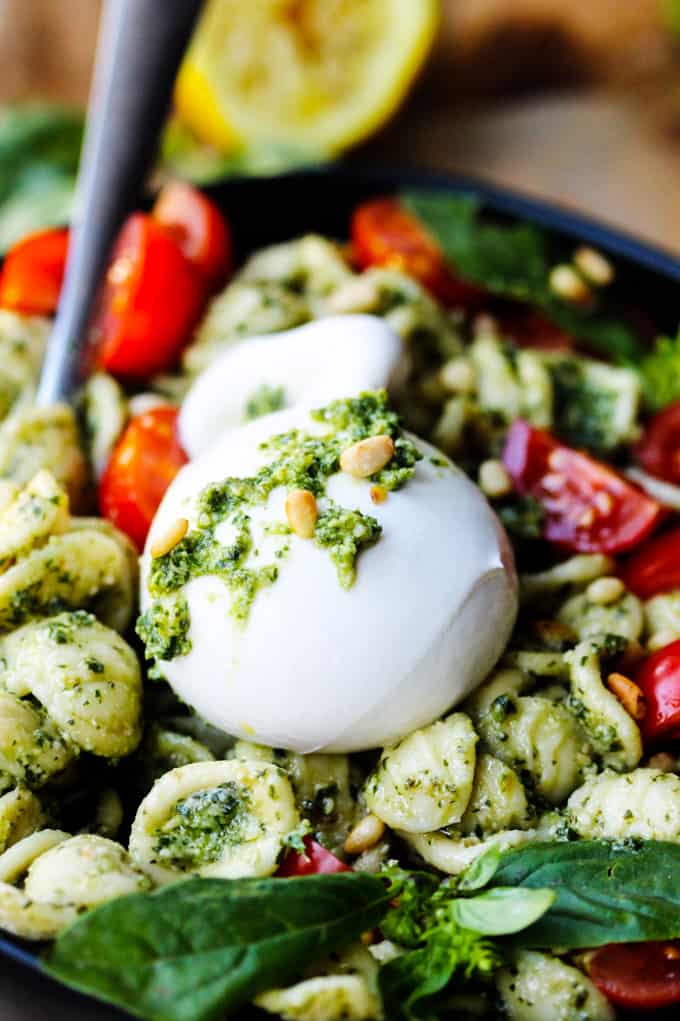 Burrata Cheese Bowl on a plate with pesto pasta and cheery tomatoes