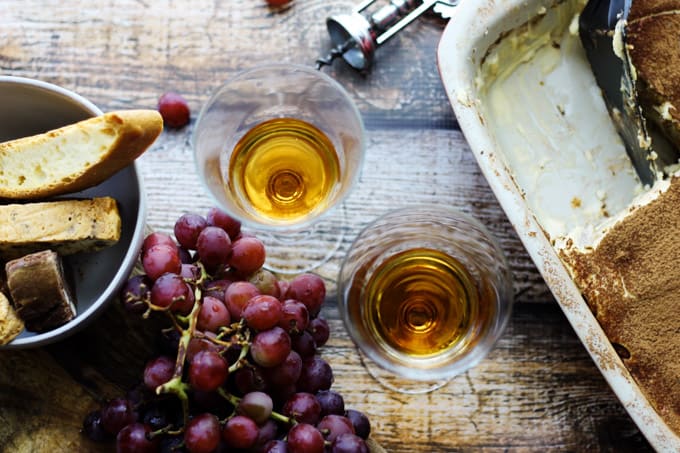 Italian Dessert Wine Passito in glasses with grapes and desserts on a side