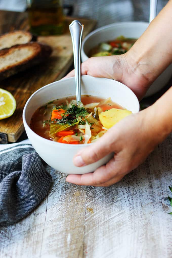 Serving slow cooker cabbage soup in a bowl