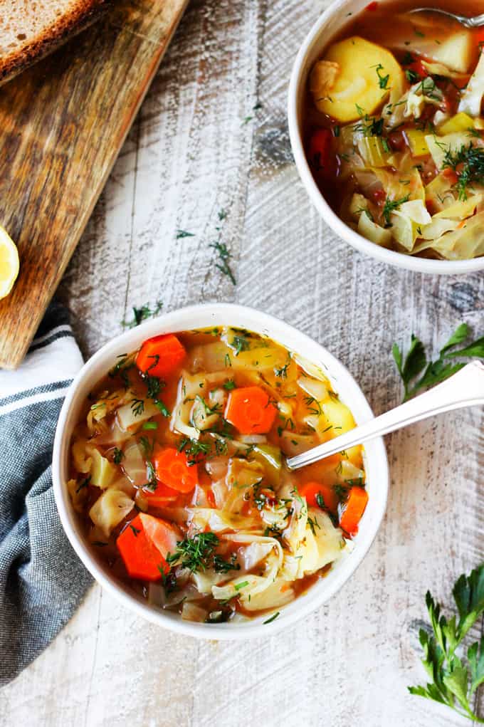2 bowls of slow cooker cabbage soup with spoon