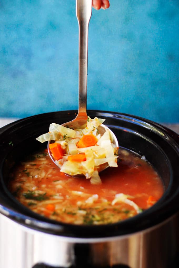 Cabbage Soup in a slow cooker with ladle 
