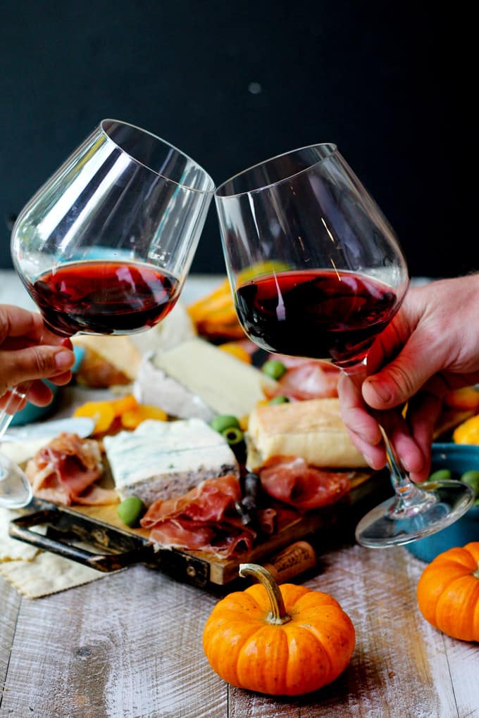 Glasses of red Italian wine and cheese with meat board