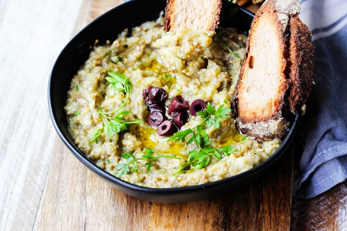 Melitzanosalata - Greek Eggplant Dip in a black bowl with bread