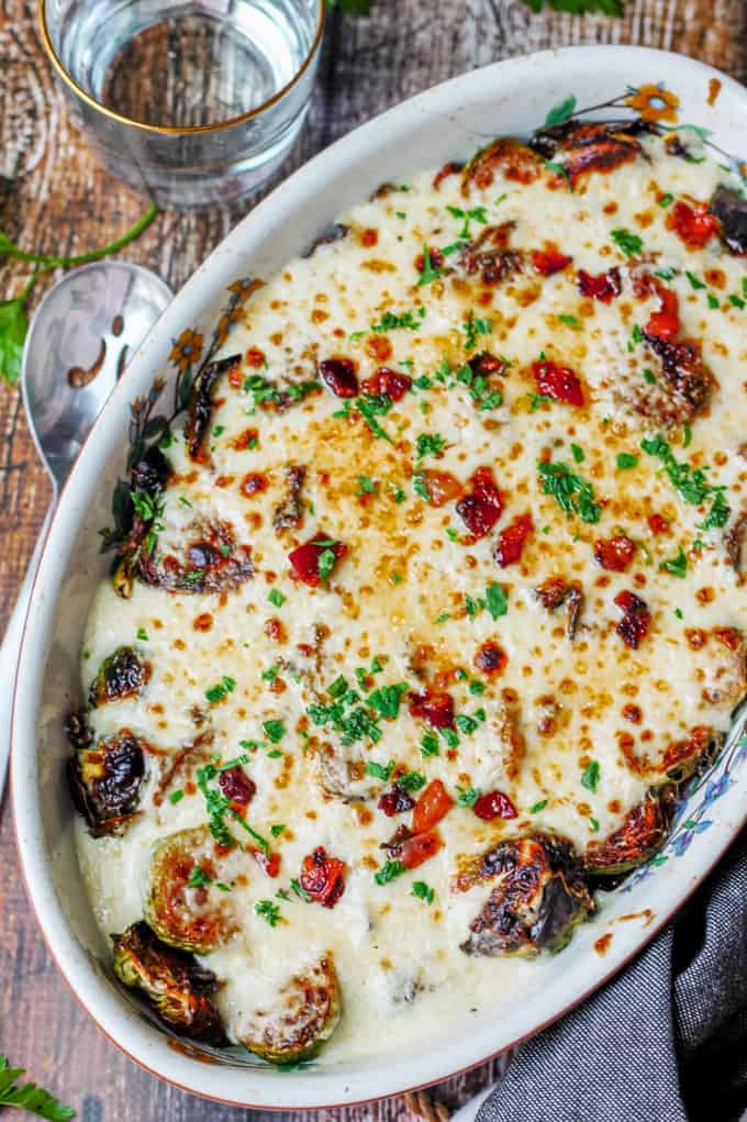 Cheesy Brussels Sprouts with bacon in an oval baking dish