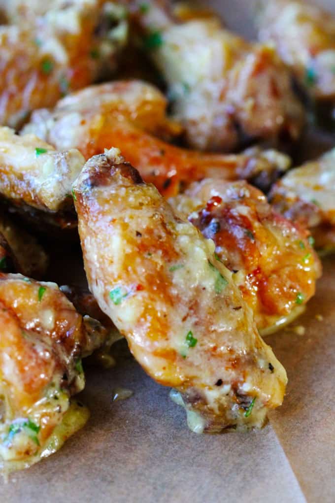 Oven baked chicken wings covered in parmesan garlic sauce