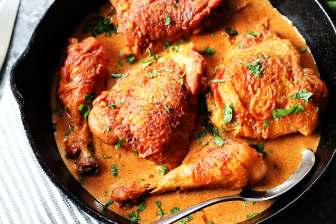 Chicken paprikash in a cast iron skillet with spoon
