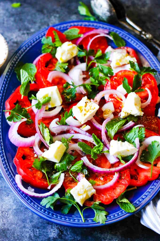 Tomato and Feta Salad on a blue serving plate