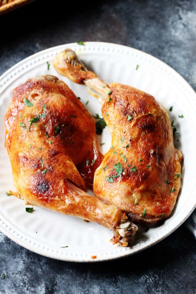 slow roasted chicken legs on a white plate