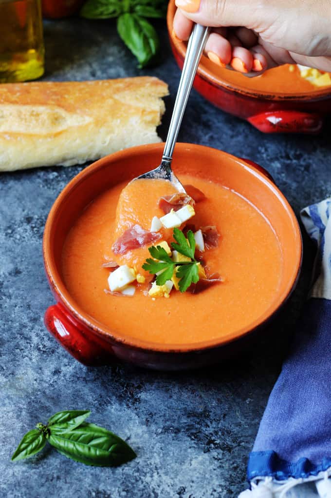 Spanish Cold Tomato Soup with Egg and Ham on a spoon