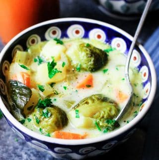 Brussels sprouts soup in a bowl with a spoon