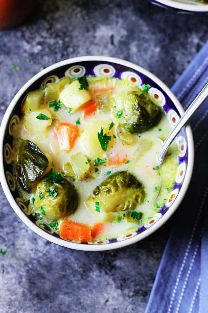 Overhead photo of brussels sprouts soup in a bowl with spoon