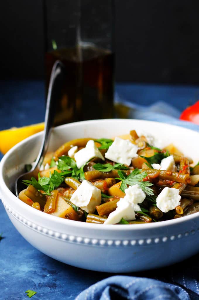 Greek Green Beans in a white bowl with feta