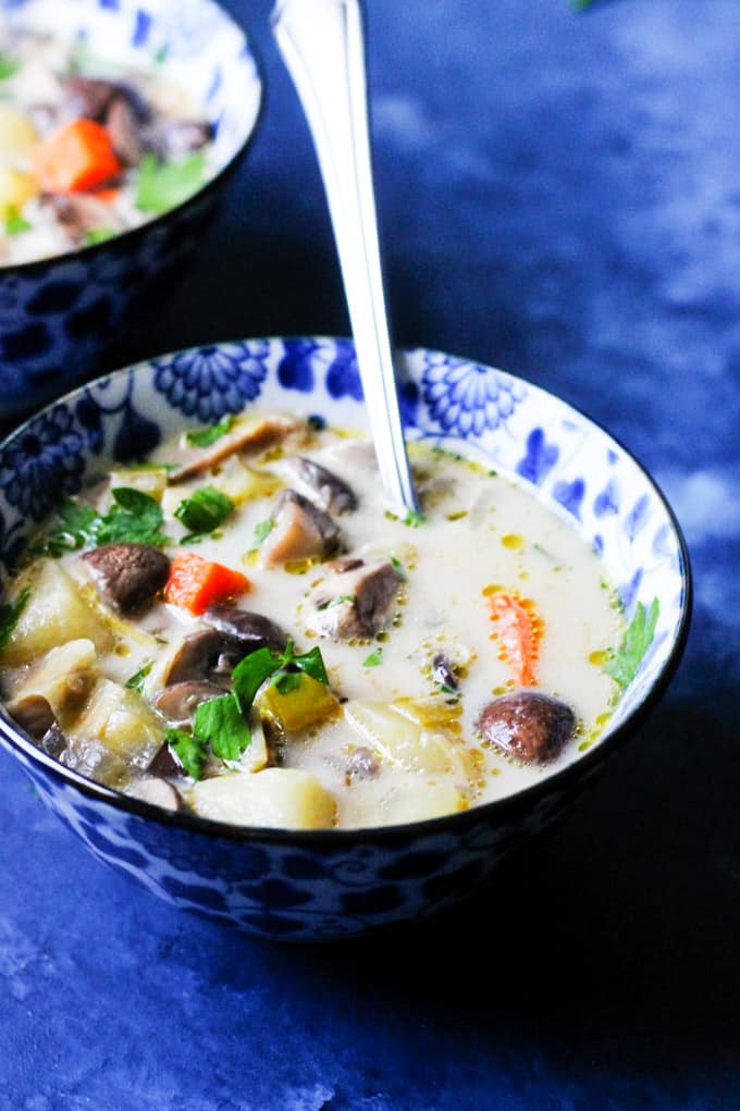 Homemade chunky mushroom soup in a bowl with spoon 