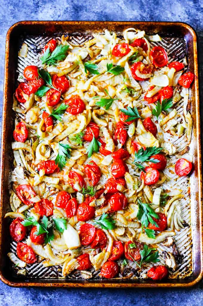 Roasted fennel and tomatoes on a baking sheet
