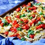 Roasted fennel with tomatoes on a cookie sheet