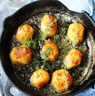 Horizontal Photo of Fondant potatoes in a cast iron sklllet