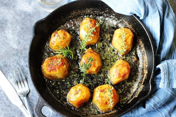 Horizontal Photo of Fondant potatoes in a cast iron sklllet