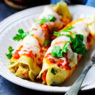 Savory Crepes with chicken and mozzarella on a plate with parsley on top