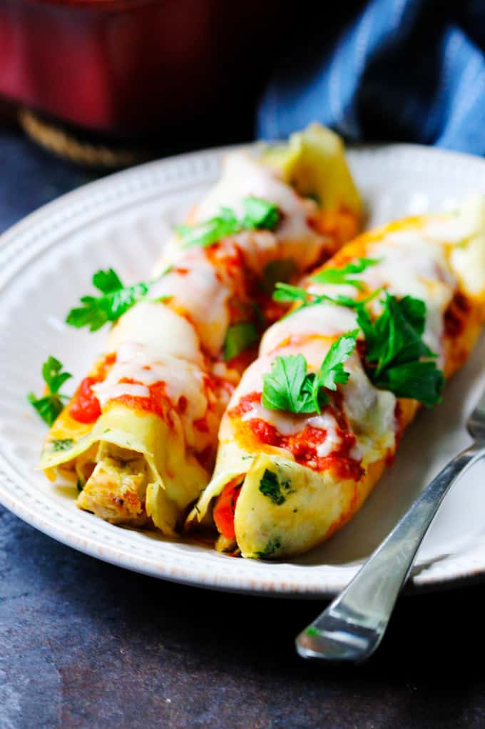 Savory Crepes with chicken and mozzarella on a plate with parsley on top