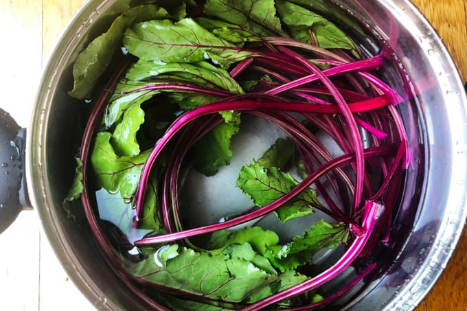 Beet greens in a pot with water