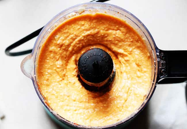 A picture of blended greek feta dip in a food processor