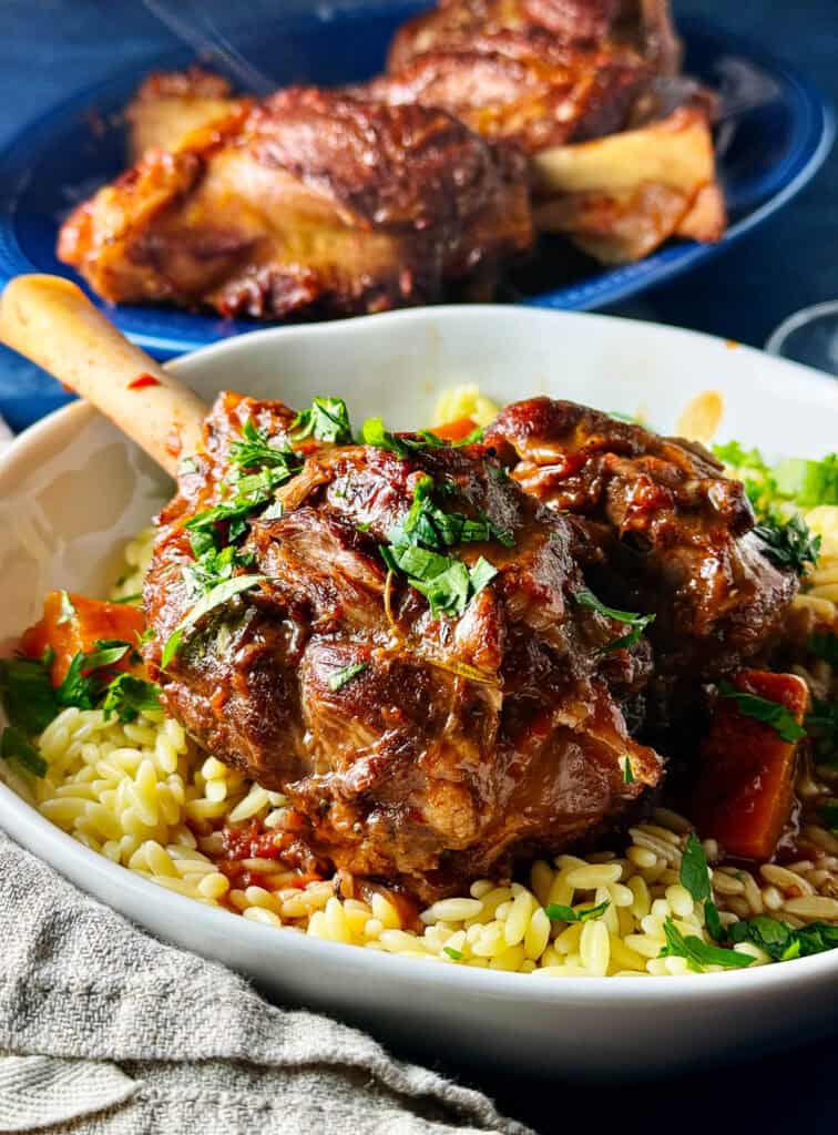 Braised lamb shank on a plate with barley