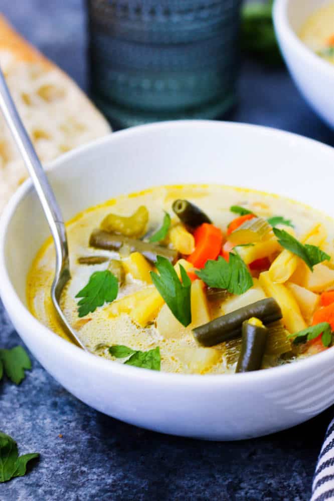 A bowl of string bean and potato soup
