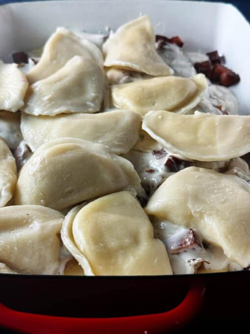 Second layer of pierogi is added