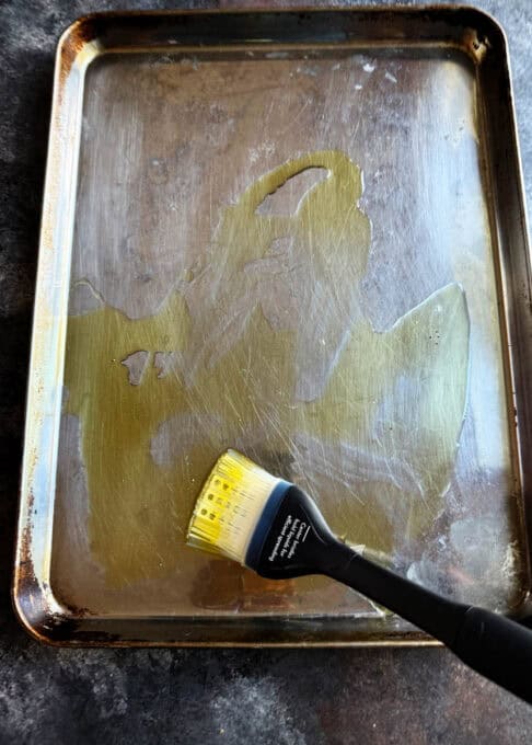 Baking sheet with olive oil spread on it