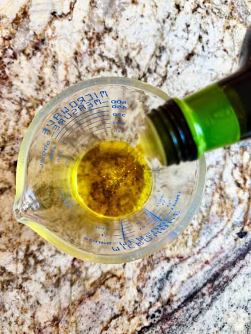 Adding olive oil to bowl