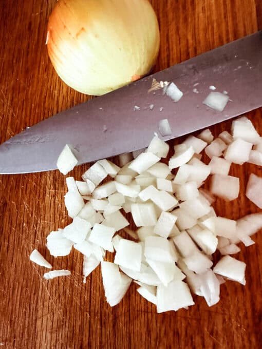 Chopped up onion on a cutting board