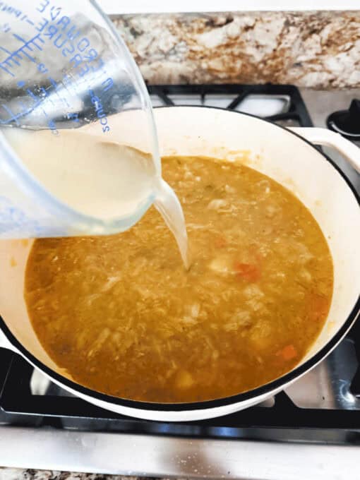 Broth is being poured into the soup