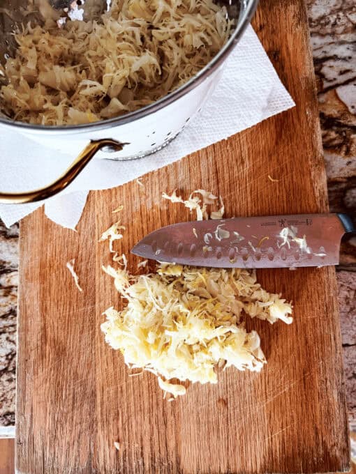 Chopped up sauerkraut on a chopping board
